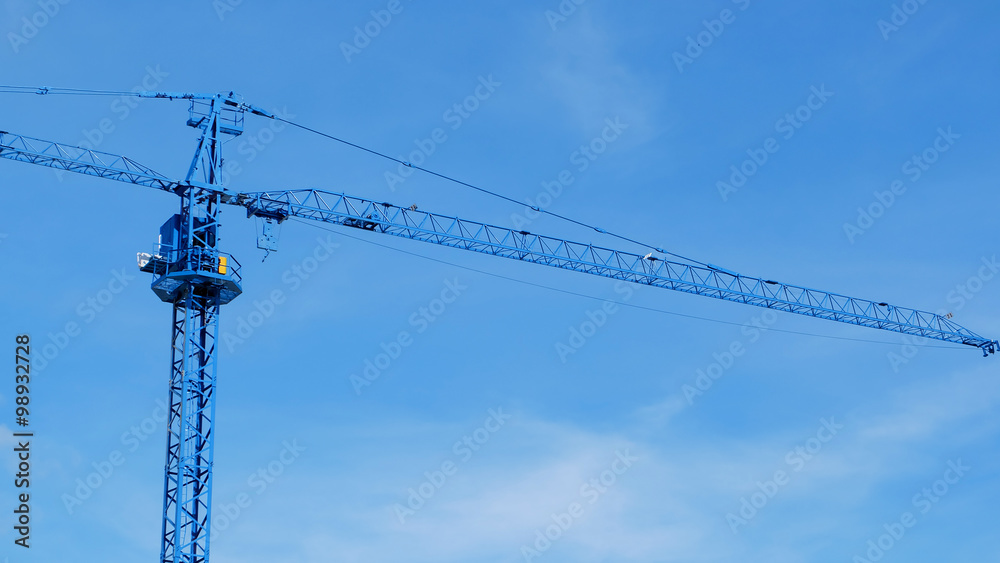 large construction crane machine with clear blue sky background large construction crane machine with clear blue sky background