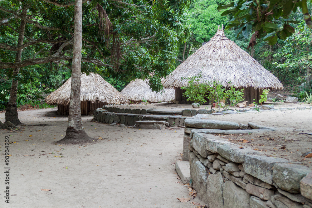 Traditional rustic houses of indigenous Kogi people in Tayrona National Park, Colombia Traditional rustic houses of indigenous Kogi people in Tayrona National Park, Colombia