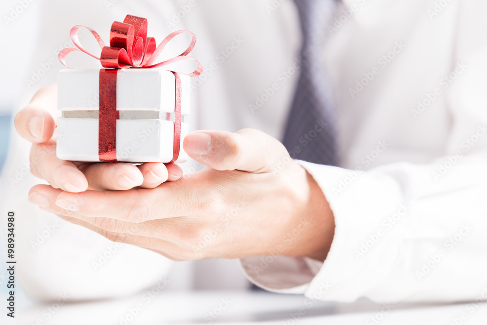 Business man offering a gift Business man offering a gift