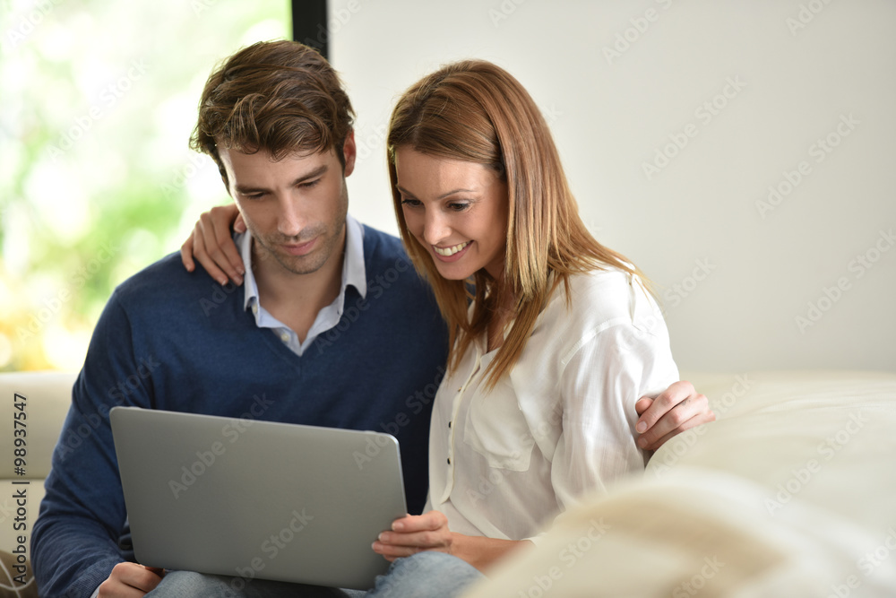 Couple at home using laptop computer Couple at home using laptop computer