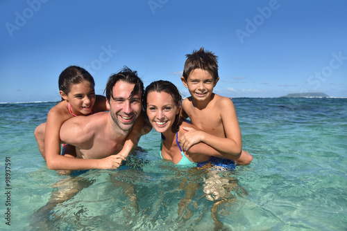 Tableau sur toile Happy family enjoying swimming in caribbean sea