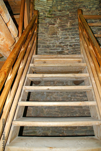Wooden staircase inside the stone tower