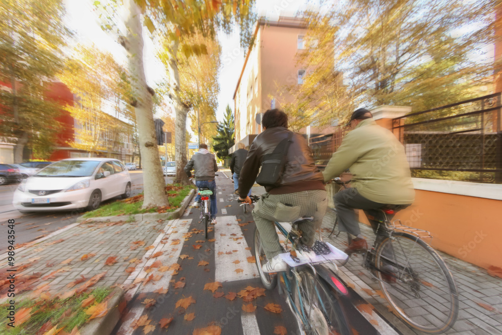 group of friends cycling around the street group of friends cycling around the street