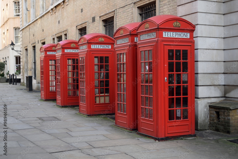 Traditional British red telephone boxes in a row Traditional British red telephone boxes in a row