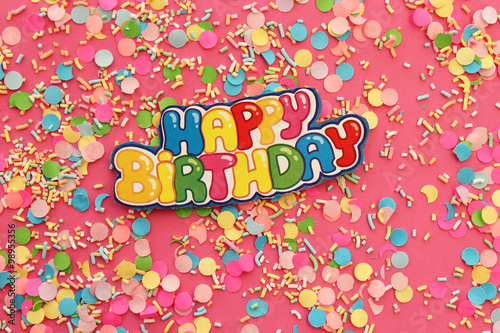 Happy birthday greeting card on pink background - confetti background