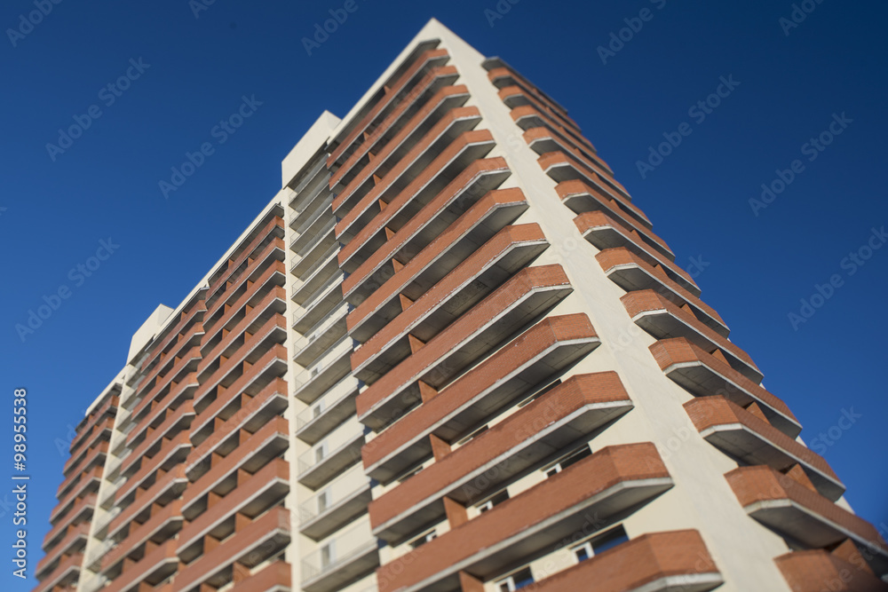 high residential building on a background of blue sky with tilt-shift effect
high residential building on a background of blue sky with tilt-shift effect