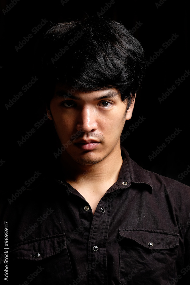 Fototapeta premium Asian man portrait in the dark