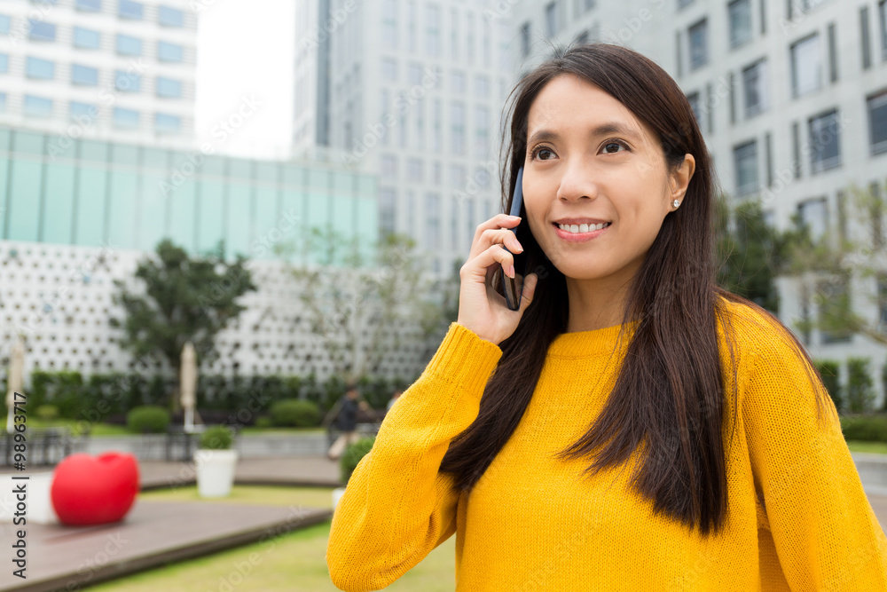 Asian Woman chatting on cellphone