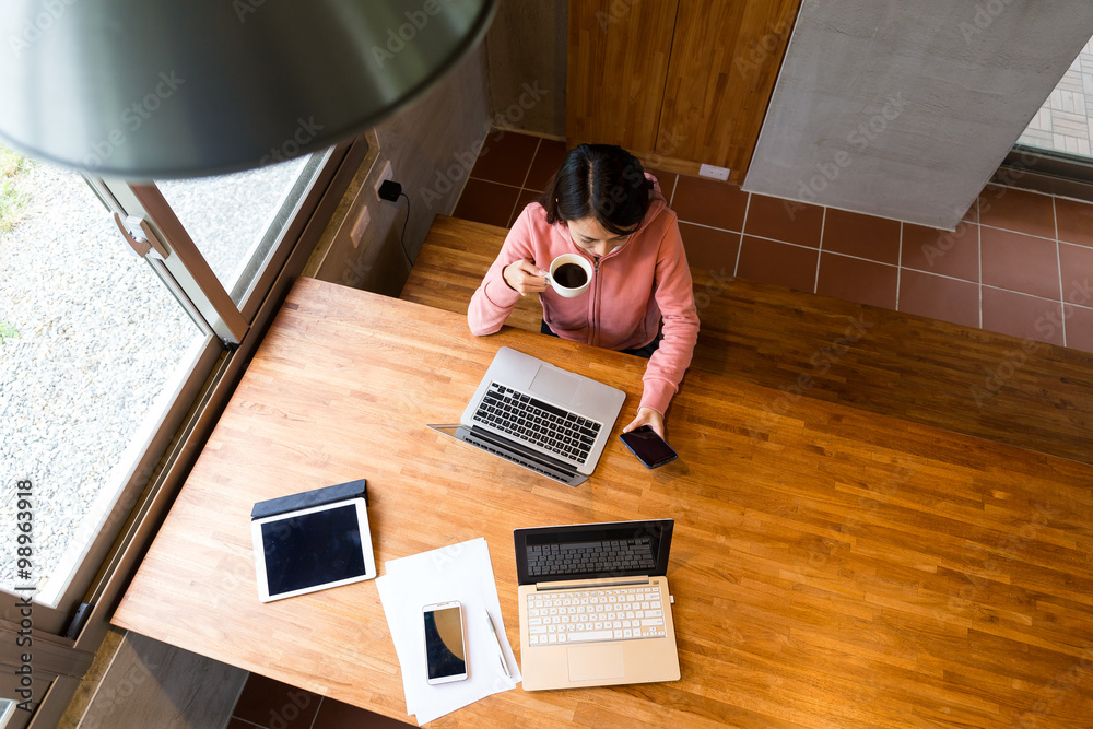 Top view of woman drinking of coffee with checking the message o Top view of woman drinking of coffee with checking the message o