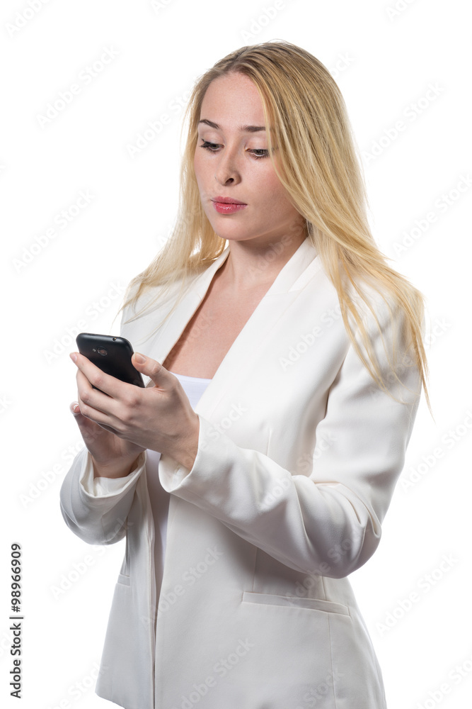 Young business woman in white casual suit looking at her mobile phone portrait. In light colors isolated on white background.