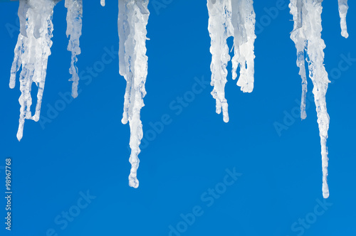 Icicles hanging from roof against the sky