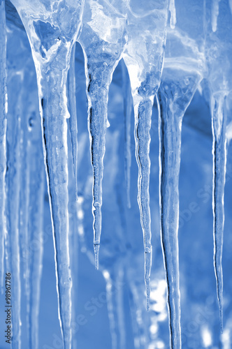 Fototapeta Background of bright transparent icicles in the sunlight