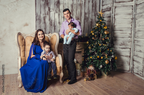 A young family of four in new year interior
