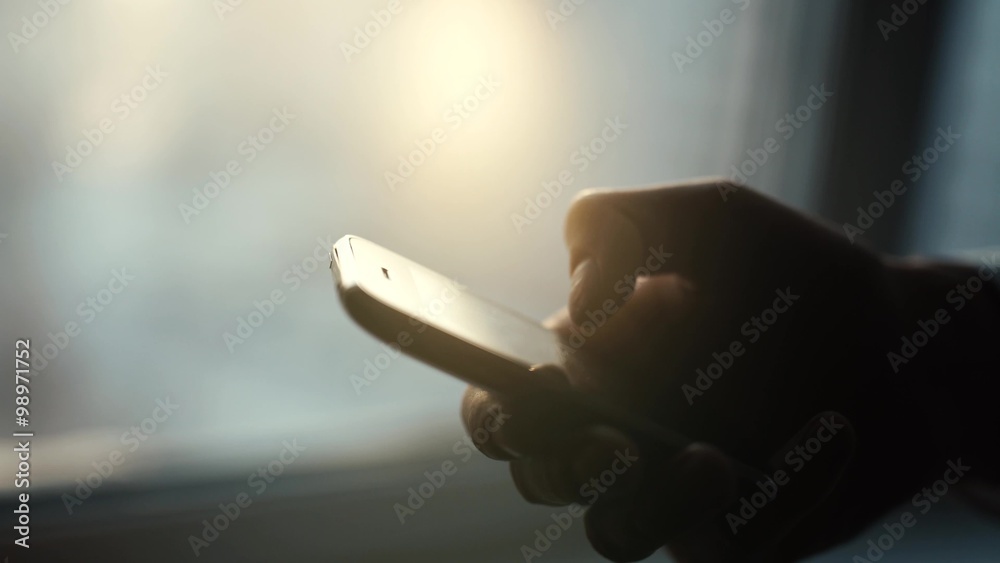 Close up of a man using mobile smart phone outdoor