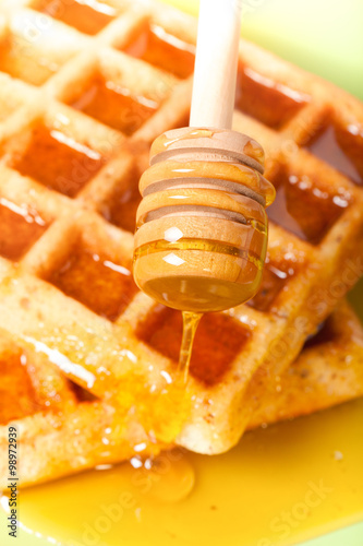 Traditional belgium soft fresh waffles with a honey. Selective f