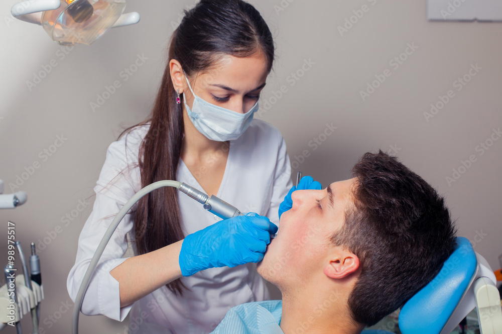 Man having teeth examined at dentists dental treatment Man having teeth examined at dentists dental treatment