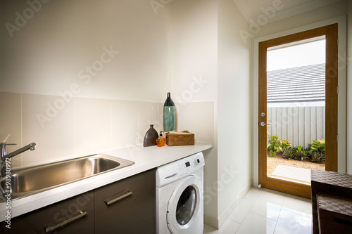 Beautiful washing room with a washing machine and sink