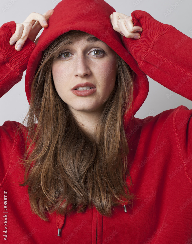 protection concept - beautiful streetwear young woman covering her head  with red hoodie for self-protection,studio shot Stock Photo | Adobe Stock