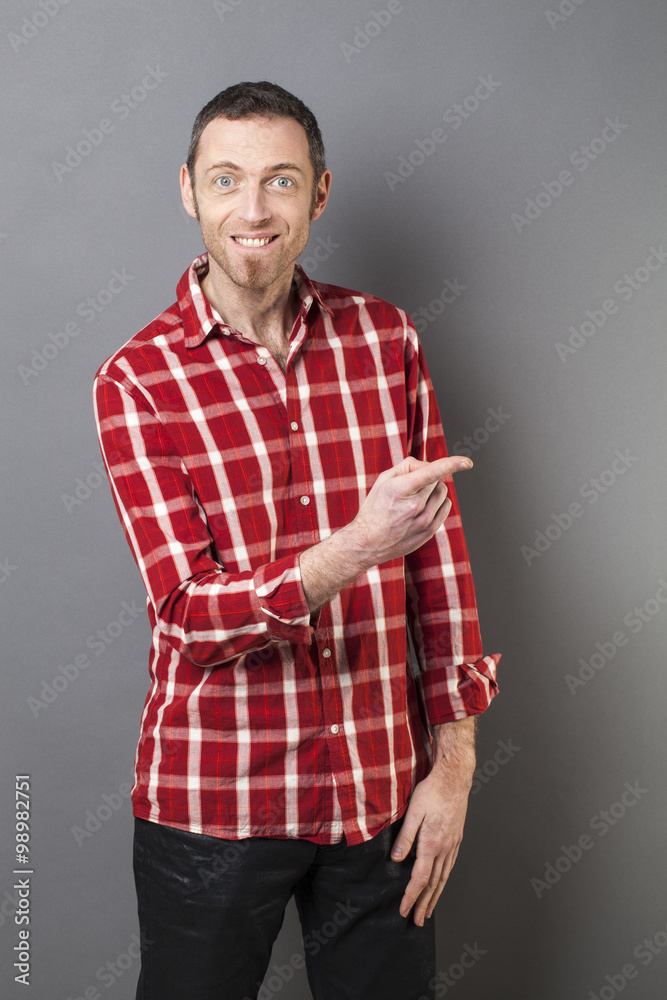 hand gesture concept - excited 40s man with checked shirt pointing his finger to show something on his side,studio shot hand gesture concept - excited 40s man with checked shirt pointing his finger to show something on his side,studio shot