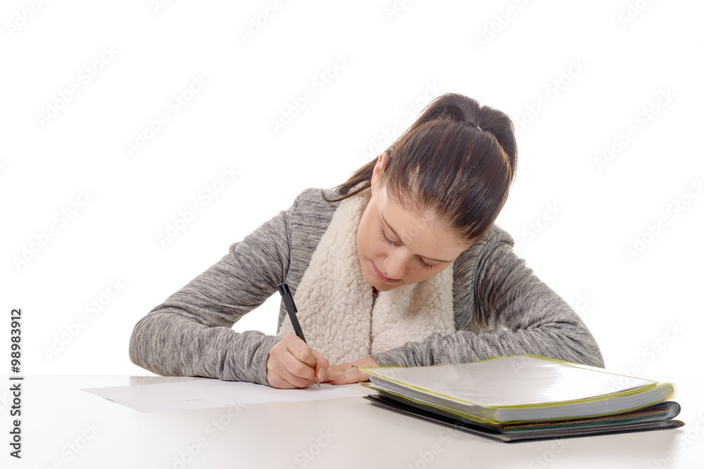 pretty young woman writing on her desk pretty young woman writing on her desk