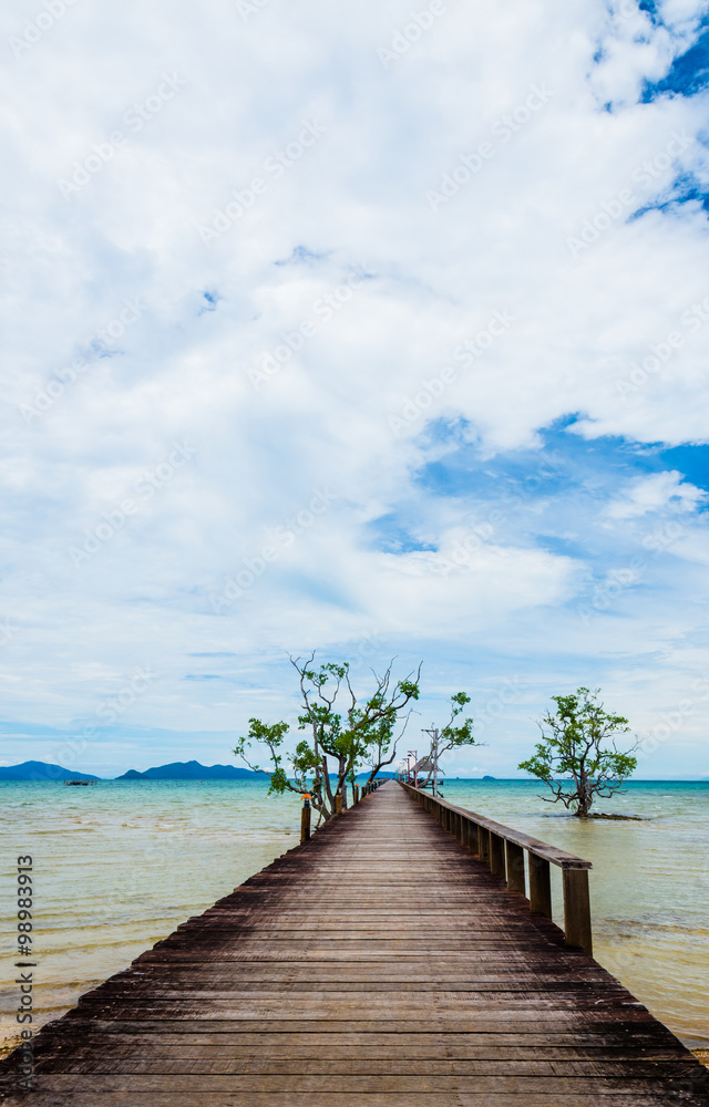 Fototapeta premium Image of old and long hardwood bridge on the sea in Thailand