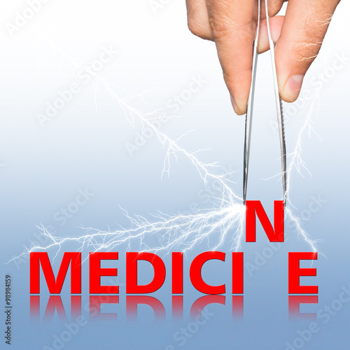 hand with forceps and word medicine