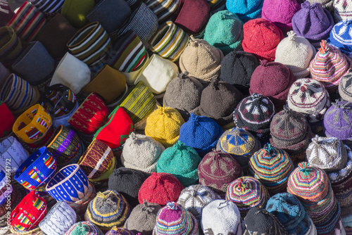 Muslim woman selling hats in a Market stall in the Marrakech sou © Andrea