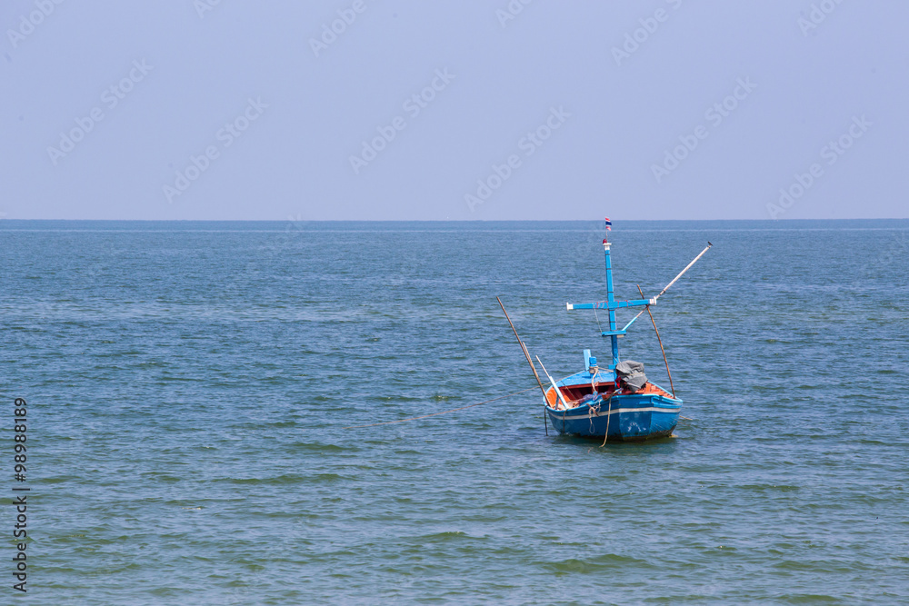 mini single fishery boat floating on sea