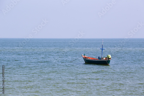 single mini fishery boat floating on sea
