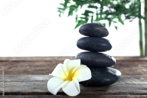 Spa stones, a candle and a lotus, isolated on white