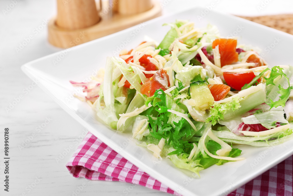 Tasty salmon salad on wooden table background Tasty salmon salad on wooden table background