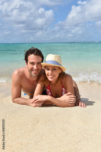 Couple relaxing on the beach in Caribbean island © goodluz