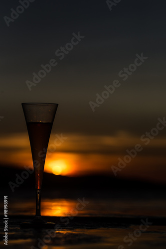 Champagne flute glass against sunset