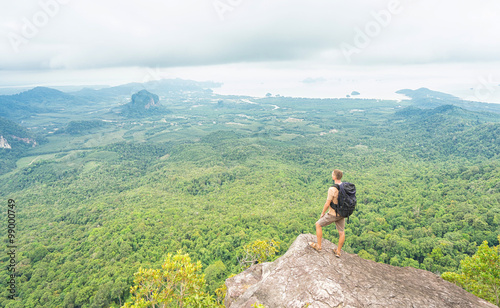 Freedom traveler man standing and enjoying a beautiful nature from top of mountain. Thailand. Krabi. 