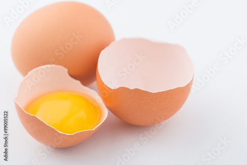 Chicken eggs are on white surface.