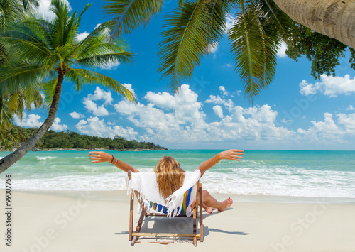 Girl on a tropical beach in chair