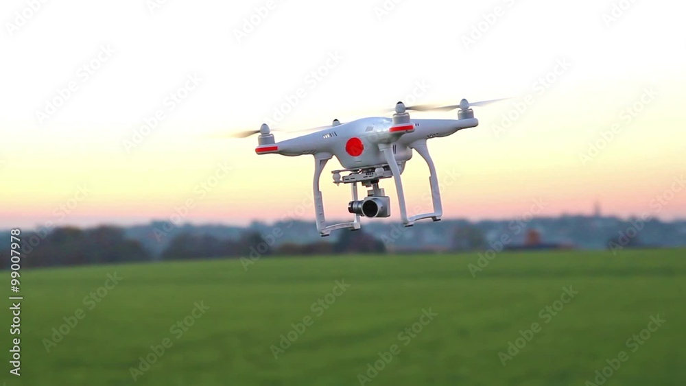 Modern RC UAV Drone / Quadcopter with camera flying on a clear sky Modern RC UAV Drone / Quadcopter with camera flying on a clear sky