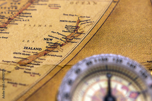 Fototapeta Old compass on vintage map selective focus on New zealand