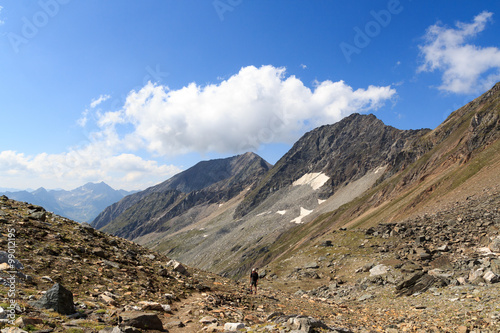 Mountain panorama (Kreuzspitze and Zopetspitze) and male mountaineer in Hohe Tauern Alps, Austria