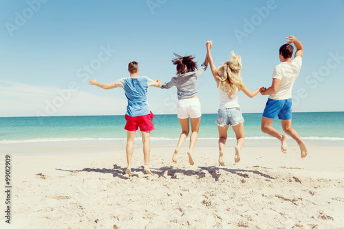 Company of young people on the beach