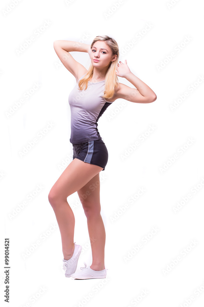 Attractive fit woman exercising in studio with copyspace. Image of healthy young female athlete doing fitness workout against grey background. Attractive fit woman exercising in studio with copyspace. Image of healthy young female athlete doing fitness workout against grey background.