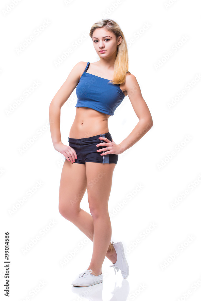 Attractive fit woman exercising in studio with copyspace. Image of healthy young female athlete doing fitness workout against grey background. Attractive fit woman exercising in studio with copyspace. Image of healthy young female athlete doing fitness workout against grey background.