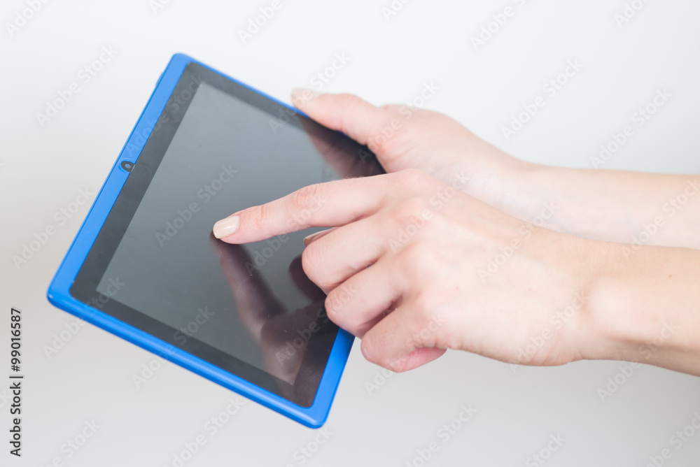 Womans hands holding a tblet on white Womans hands holding a tblet on white