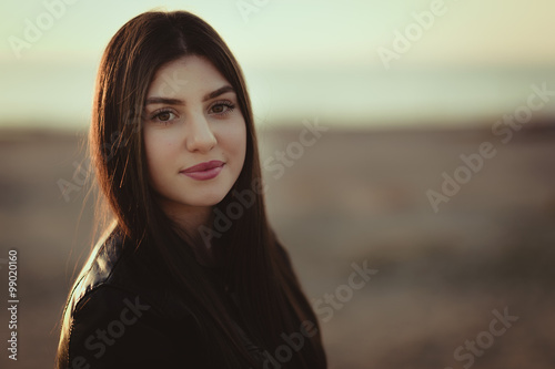 Beautiful girl with sunset sea background