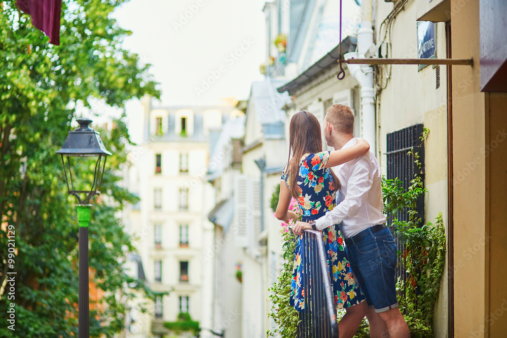 Romantic couple on the balcony decorated with flowers