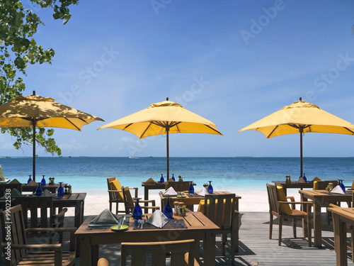 tropical beach restaurant in front of blue ocean