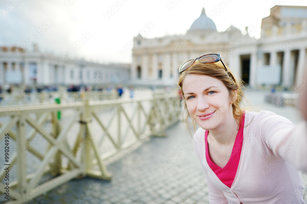 Beautiful young woman taking a picture of herself in Vatican