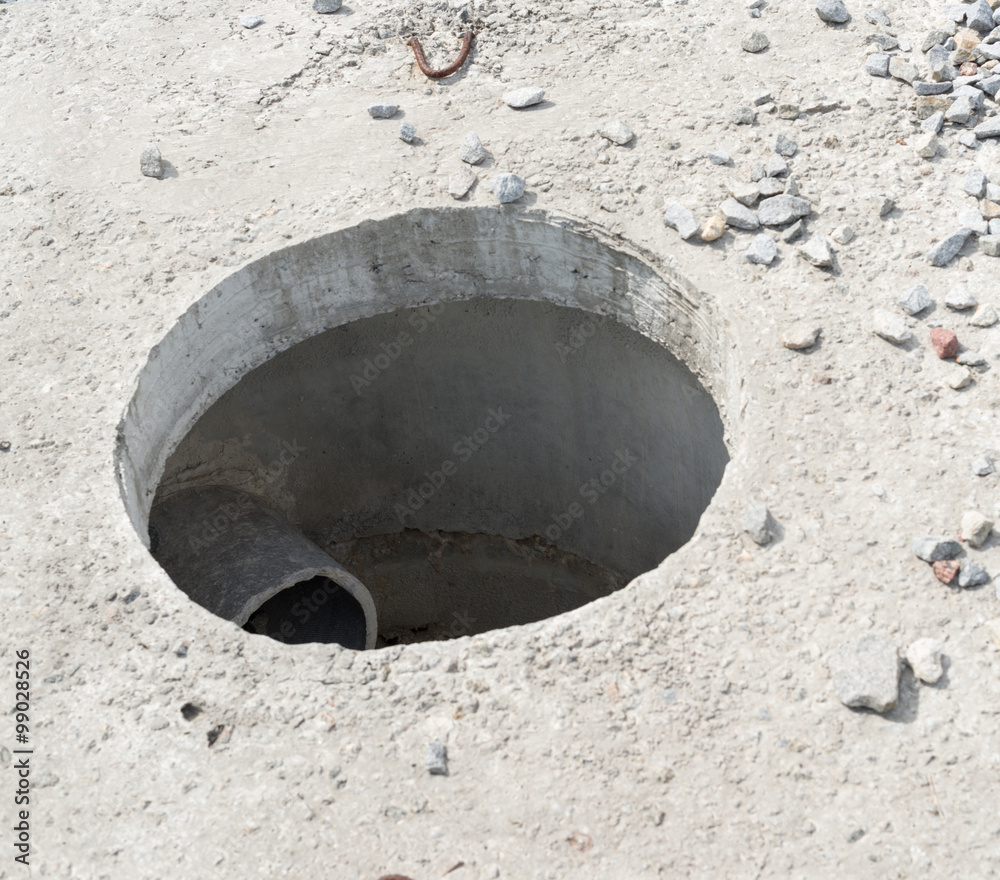 Manhole without cover in new concrete block