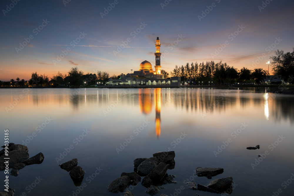 Perfect reflection of a floating mosque Masjid Tengku Tengah Zaharah in Kuala Ibai, Terengganu, Malaysia during sunset