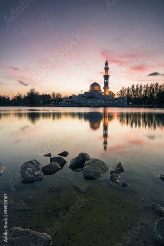 Perfect reflection of a floating mosque Masjid Tengku Tengah Zaharah in Kuala Ibai, Terengganu, Malaysia during sunset photo